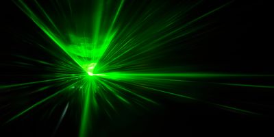 Green laser on black background