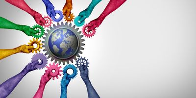 Many multicolored hands holding cogs towards a larger cog surrounding a globe