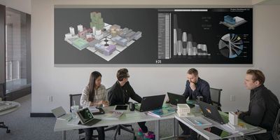 Lab planners view a 3D render of a building