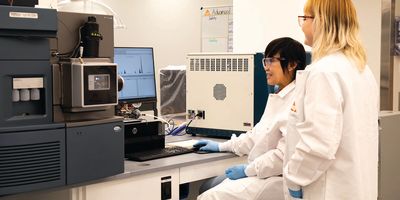 Two USP scientists work at a workstation