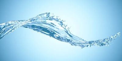 Clear water splash on light blue background