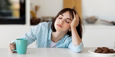 Very tired woman, drinking coffee