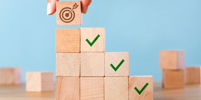 Wooden blocks stacked to represent goal setting