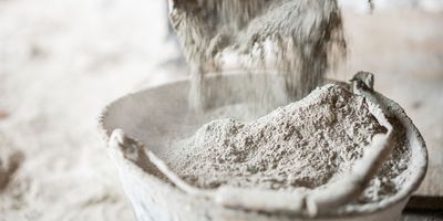 Close up of concrete being poured into a bucket