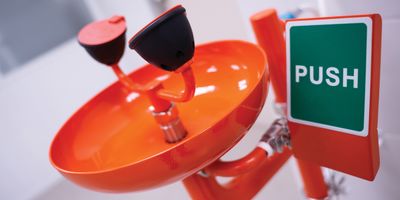 Orange emergency eyewash station in a laboratory