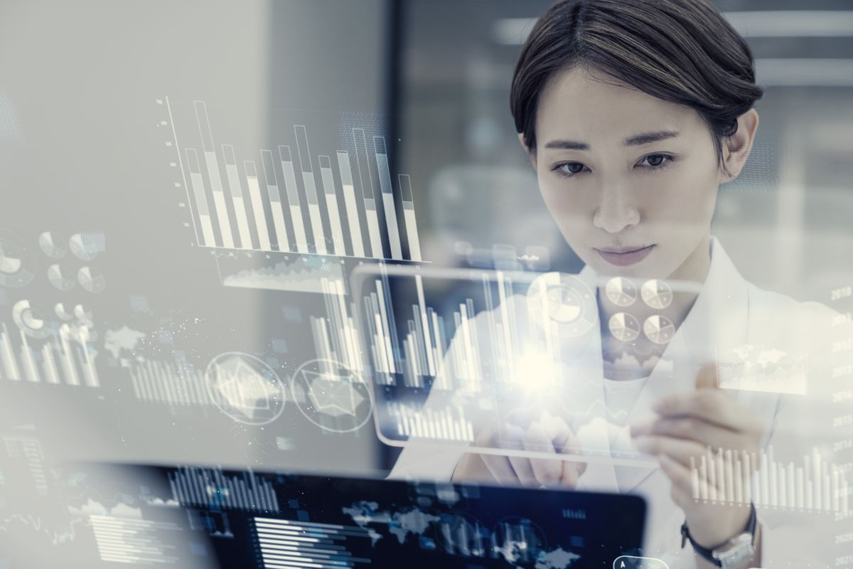 Young female scientist analyzes data on a holographic display