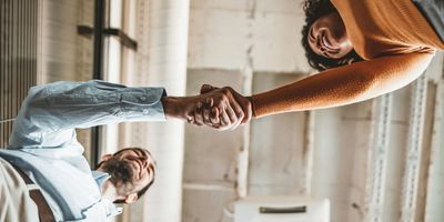 Two people shake hands