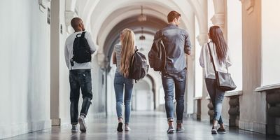 Four students walking to class at university