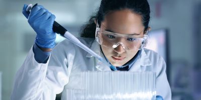 Young researcher pipetting liquid