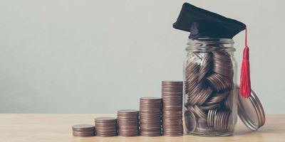 Stacks of change leading to a jar full of coin, with a university graduation hat on top