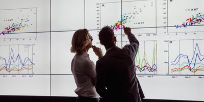 Two researchers looking at charted data