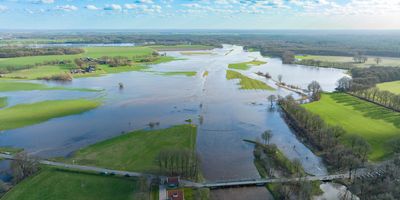 A flooded field next to a river