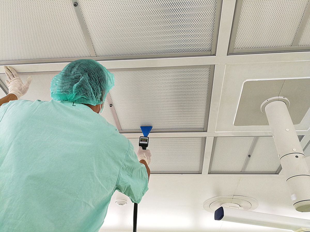 Worker in PPE tests HEPA filters in lab