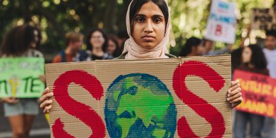 Women protestor holding a sign against climate change