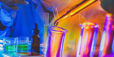 A collection of colorful test tubes and glassware in a lab