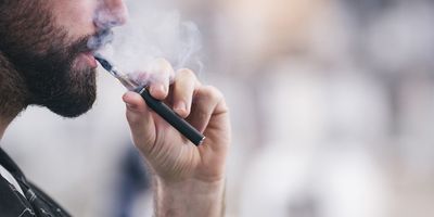 Man vaping using e-cigarette