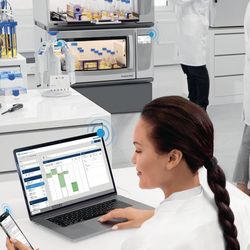 scientists working in a lab with digital monitoring