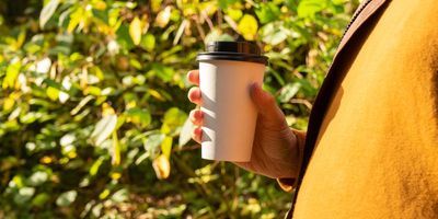 Woman walking with a cp of coffee