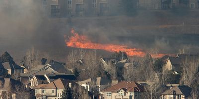 Wildfire burns near a group of homes