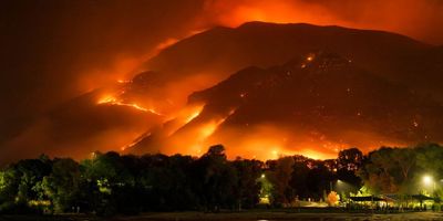 A wildfire burns across a mountain