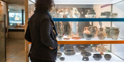 Person in a museum looking at artifacts