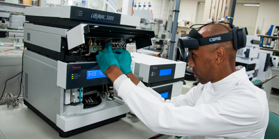 Maintenance technician uses a mixed reality headset to service an instrument