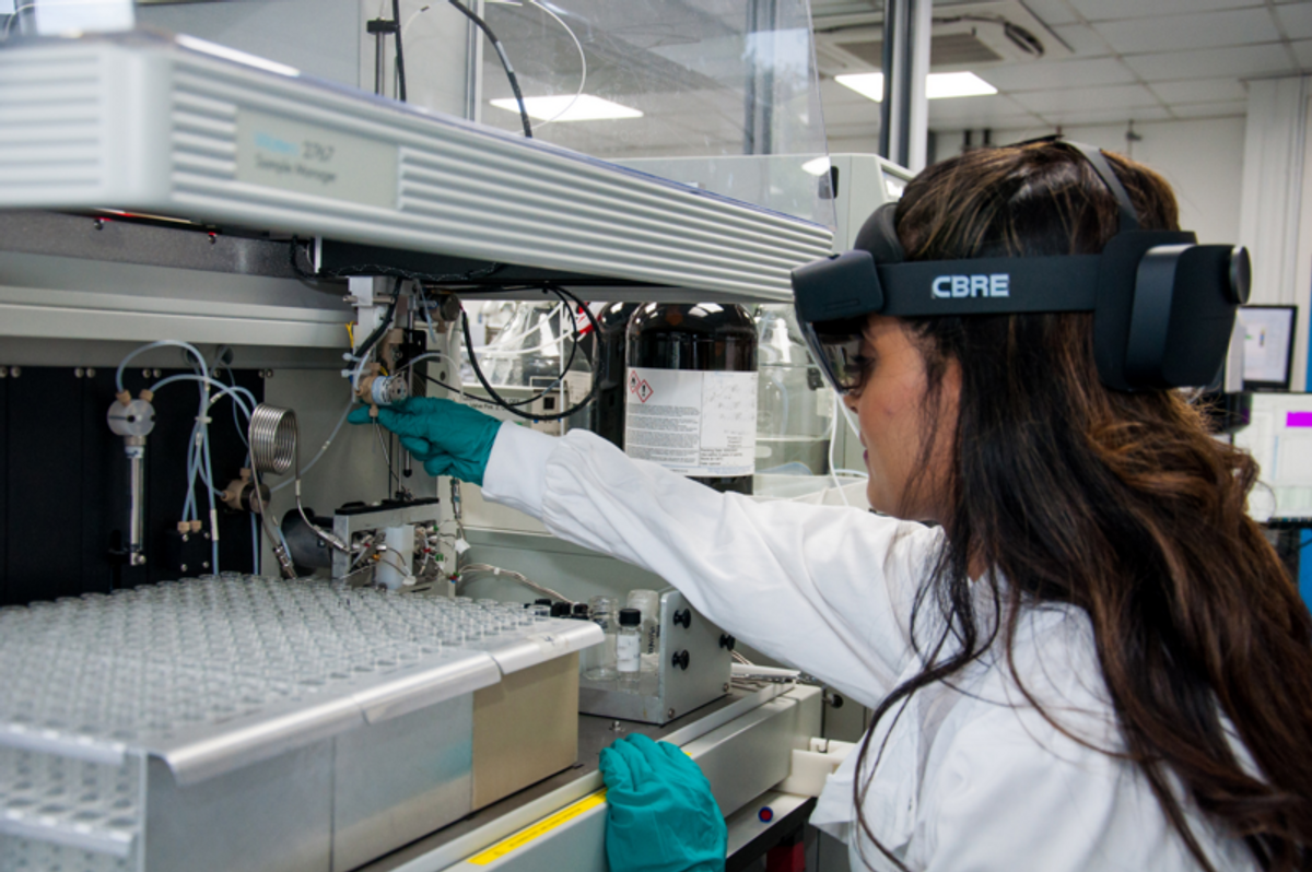 Lab technician services a liquid handler with a mixed reality headset